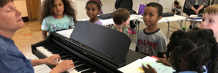 Children in beginning keyboard class learn a new song