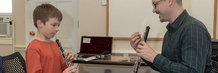 Colton Ray Cox teaches a young oboist 